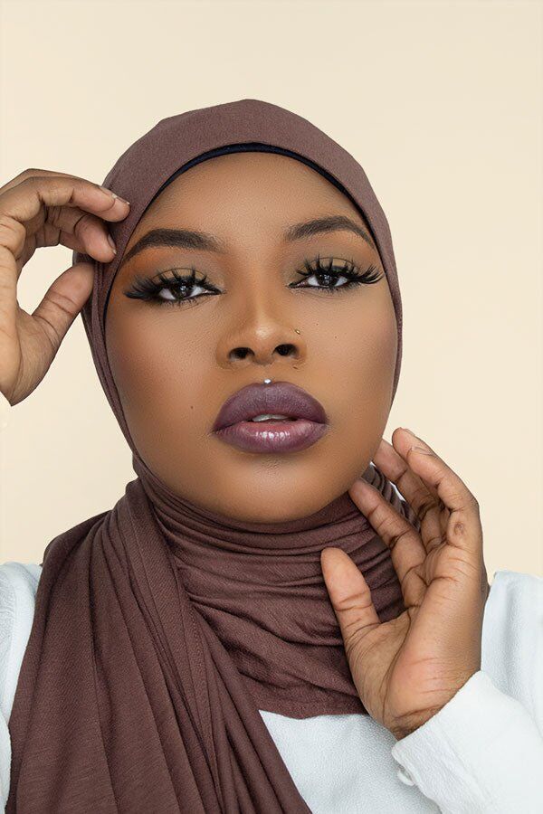 Stylish woman confidently flaunting the instant premium jersey hijab in a chic urban setting by Hijab Kingdom